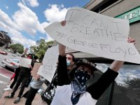 Protesters hold signs at the intersection of Union Street and County in downtown New Bedford before progressing to the site where Malcom Gracia was killed on Cedar Street in 2012.  PHOTO PETER PEREIRA