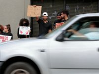 Protesters hold signs at the intersection of Union Street and County in downtown New Bedford before progressing to the site where Malcom Gracia was killed on Cedar Street.  PHOTO PETER PEREIRA