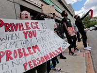 Protesters hold signs at the intersection of Union Street and County in downtown New Bedford before progressing to the site where Malcom Gracia was killed on Cedar Street.  PHOTO PETER PEREIRA