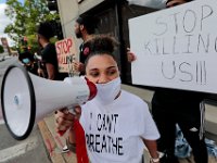 Protesters hold signs at the intersection of Union Street and County in downtown New Bedford before progressing to the site where Malcom Gracia was killed on Cedar Street.  PHOTO PETER PEREIRA]