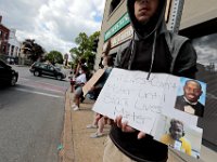 Protesters hold signs at the intersection of Union Street and County in downtown New Bedford before progressing to the site where Malcom Gracia was killed on Cedar Street.  PHOTO PETER PEREIRA