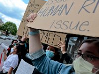 Protesters hold signs at the intersection of Union Street and County in downtown New Bedford before progressing to the site where Malcom Gracia was killed on Cedar Street.  PHOTO PETER PEREIRA