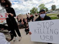 Protestors observe a moment of silence at the site where Malcom Gracia was killed by police on Cedar Street in 2012.  PHOTO PETER PEREIRA