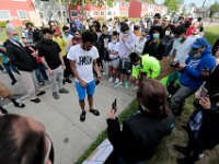 Protestors take a closer look at a sign outlining the evens in 2012 that saw the death of Malcom Gracia being fataly shot by police on Cedar Street in New Bedford.   PHOTO PETER PEREIRA