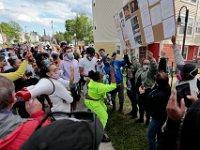 Protestors take a closer look at a sign outlining the evens in 2012 that saw the death of Malcom Gracia being fataly shot by police on Cedar Street in New Bedford.   PHOTO PETER PEREIRA