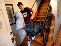 Victor Gonsalves grabs his pillow, a duffle bag and backpack from his room, as he prepares to leave from his home on Harvard Street in New Bedford  for his first year at Harvard University.  PHOTO PETER PEREIRA