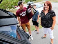 Victor Gonsalves enjoys a good laugh with his mother, Raquel Bourguignon, wondering how everything will fit into the back of the SUV as he prepares to leave from his home on Harvard Street in New Bedford  for his first year at Harvard University.  PHOTO PETER PEREIRA