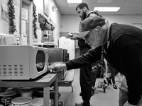 Robert Hughes, program director, heats a meal for a resident at the House of Hope homeless shelter on Mount Pleasant Street in New Bedford.