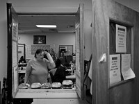 Marie Smith decides which meal to eat for lunch at the House of Hope homeless shelter on Mount Pleasant Street in New Bedford.