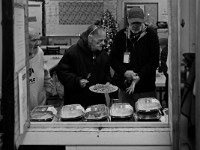 Lynn Jenness, center, helps prepare a lunch for a resident of the House of Hope homeless shelter on Mount Pleasant Street in New Bedford.