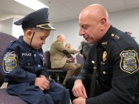 Deputy Chief, Al Sousa, has a word with JJ Montalban, 6, who was born with congenial heart defects, before he was sworn in as an honorary New Bedford police officer at a ceremony held at police headquarters on Rockdale Avenue in New Bedford.  JJ Montalban is currently in need of a heart transplant. PHOTO PETER PEREIRA