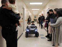 JJ Montalban, 6, who was born with various congenial heart defects, gives his sister Mikaelah Montablan a ride aboard his new cruiser after he was sworn in as an honorary New Bedford police officer at a ceremony held at police headquarters on Rockdale Avenue in New Bedford.   JJ Montalban, who was born with various congenial heart defects, is currently in need of a heart transplant. PHOTO PETER PEREIRA