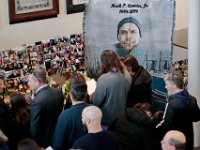 A tapestry featuring a photo of Mark Cormier Jr. looks on, as family and friends attend a service in celebration of Mark's life held at the Seamen's Bethel in New Bedford.  Mark Cormier Jr., 35, along with two other fishermen were lost at sea aboard the New Bedford fishing vessel Leonardo on November 24, 2019.   PHOTO PETER PEREIRA