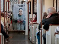 A tapestry featuring a photo of Mark Cormier Jr. looks on, as family and friends attend a service in celebration of Mark's life held at the Seamen's Bethel in New Bedford.  Mark Cormier Jr., 35, along with two other fishermen were lost at sea aboard the New Bedford fishing vessel Leonardo on November 24, 2019.   PHOTO PETER PEREIRA