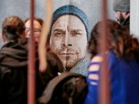 A tapestry featuring a photo of Mark Cormier Jr. looks on, as family and friends attend a service in celebration of Mark's life held at the Seamen's Bethel in New Bedford.  Mark Cormier Jr., 35, along with two other fishermen were lost at sea aboard the New Bedford fishing vessel Leonardo on November 24, 2019.   PHOTO PETER PEREIRA