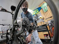 Scott Martin repairs the disk brakes on a mountain bike at his Scottee's Westport Bicycle on Route 6 in Westport.  PHOTO PETER PEREIRA