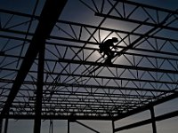 The sun shines behind the silhouette of Brian Jackowitz, foreman, as he welds the bridging on the steel structure of the new fire station being built next to the existing police station on Route 6 in Mattapoisett.  PHOTO PETER PEREIRA