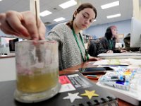 Voc-Tech senior, Kelsey Ferreira, 18, cleans out her paint brush, as she works on painting a childrens book in her visual design class.  PHOTO PETER PEREIRA