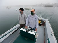 Peter Costa, right, and his son Silas Costa of Triad Boatworks head out into Mattapoisett harbor on a foggy morning to pull a boat out of the water  for the season.  PHOTO PETER PEREIRA