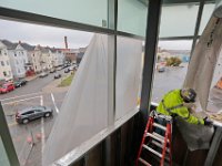 Keith Smith of Customs Drywall, works on the curtain wall window frame that will span the fitness room of the new Fire and Police station being built on Brock Avenue in New Bedford. PHOTO PETER PEREIRA