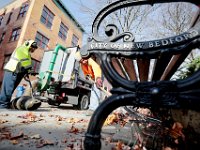 Anthony Ramos uses a giant vaccum as he and Gary Magnet work together to collect the fallen leaves in downtown New Bedford. PHOTO PETER PEREIRA