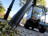 Jordan Oliver uses the Madvac to suck up some of the fallen leaves which have accumulated on curbings around Custom House square in downtown New Bedford.  PHOTO PETER PEREIRA]