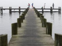 Men fish from a dock in the south end of New Bedford on a very foggy morning.   PHOTO PETER PEREIRA