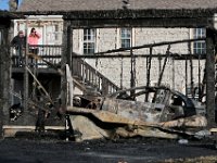 Alexandra Brum is in a state of shock as she returns home to see the aftermath of the garage which abuts her property and burned to the ground on Hamlin Street.  Beside her is Joe Medeiros who also owns property to the left of the garage. PHOTO PETER PEREIRA