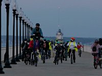 The Butler Flats lighthouse peeks out in the distance as Civitron of New Bedford Starchasers, leads Youth Opportunities Unlimited members for a sunset bike ride around Fort Taber Park in the south end of New Bedford.  PHOTO PETER PEREIRA
