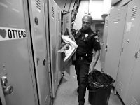 Officer Carlos DePina moves his personal items out of his locker during the last day of operation for New Bedford police Station 2 on Cove Street in New Bedford.  Both New Bedford fire and police south end stations are relocating to a new combined station on Brock Avenue.