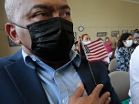 Jose Oliveira, born in Cape Verde, holds an American flag to his chest at the naturalization ceremony held at the Immigrants Assistance Center in New Bedford where twenty six people became new United States citizens.