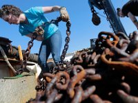 Captain Jessica Walker removes chain that needs to be replaced aboard the fishing boat Legacy currently docked in New Bedford, before heading back out to sea.