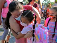 Catalina Bonilha Cruz and her daughter Emily Orellana Bonilha, 6, embrace before she joins her new first grade classmates for the first day of school at the Alfred J Gomes Elementary School in New Bedford.