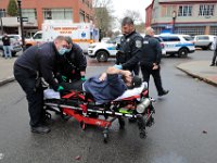 A man winces in pain as New Bedford EMS adjusts the leg he hurt during an altercation with a man at the intersection of Elm Street and Pleasant Street in downtown New Bedford.