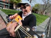 John Sedlock takes advantage of the great weather by playing his guitar at Custom House Square in downtown New Bedford.
