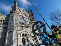 Pauly Reed of Cenaxo, handles the west facing Celtic cross, as it is lowered after he removed it from the top of the Unitarian Church in Fairhaven.  This is one of two crosses being restored at the iconic church in Fairhaven.
