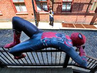 Imalay Lugo of Ever After, takes a photo of Spider-Man (Jalen Latimer) resting on the rail of an alleyway in downtown New Bedford, for promotional materials for the New Bedford character company.