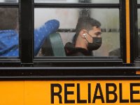 Students are seen through the windows of the buses arriving at New Bedford High School for the first day of school.