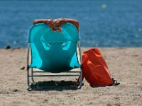A woman enjoys heat wave making its way across the region, by catching some sun rays at East Beach in New Bedford.