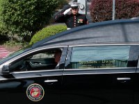 Current New Bedford police officer and fellow student of Dr. Waters, Cpl Christian Gomes (Ret.), stands at attention on Union Street and salutes the hearse carrying Dr. Herbert R. Waters, Jr., Colonel US Marine Corps (Ret.) as it drives past on its way to the funeral mass held at St. Julie Billiart church in Dartmouth. Dr. Waters was a leader in education and cultural community, especially known for his pride in his Wampanoag heritage.