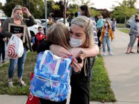 Chelsea Valliere gives her daughter, Grace Elizabeth, 7, a hug before she heads into her first day of school at the Leroy Wood School in Fairhaven.  This is the first time that students have been allowed back to the school since March.  PHOTO PETER PEREIRA