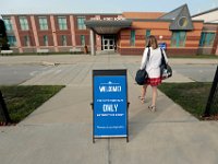 A teacher walks past the drop off limit as student and teachers arrive at the Leroy Wood School in Fairhaven for the first day of school.  This is the first time that students have been allowed back to the school since March.  PHOTO PETER PEREIRA