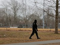 A police officer walks Cushman Park during the search for Kenneth Parks who was reported missing Wednesday afternoon in Fairhaven. Mr. Parks was found by a homeowner sitting in her car parked in her driveway on Chestnut Street.