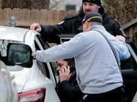 New Bedford Police and Fairhaven Firefighters speak to Kenneth Parks after he was found by a homeowner sitting in her car parked in her driveway on Chestnut Street in Fairhaven,