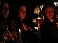 Umass Dartmouth students and staff hold candles during a candlelight vigil to honor Frankie Petillo Jr. who died after geing hit by a car, and Alexandra Landra who died unexpectedly in a separate incident.