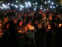 Umass Dartmouth students and staff hold candles during a candlelight vigil to honor Frankie Petillo Jr. who died after geing hit by a car, and Alexandra Landra who died unexpectedly in a separate incident.