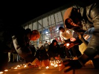 Umass Dartmouth students light small candles on the ground in front of the library during a candlelight vigil to honor Frankie Petillo Jr. who died after geing hit by a car, and Alexandra Landra who died unexpectedly in a separate incident.