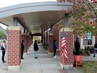 Voters line up outside the Normandin Middle School polling station in New Bedford to cast their ballots for the 2020 Presidential election.  [ PETER PEREIRA/THE STANDARD-TIMES/SCMG ]