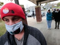 Nick Mancini wears his 'I Voted' sticker on his hat, as he escorts his mom Sharon Christmas to cast her vote at the Normandin Middle School polling station in New Bedord.   [ PETER PEREIRA/THE STANDARD-TIMES/SCMG ]