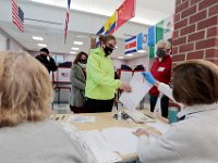 Voters check-in to receive their ballots at the Normandin Middle School polling station in New Bedford.   [ PETER PEREIRA/THE STANDARD-TIMES/SCMG ]